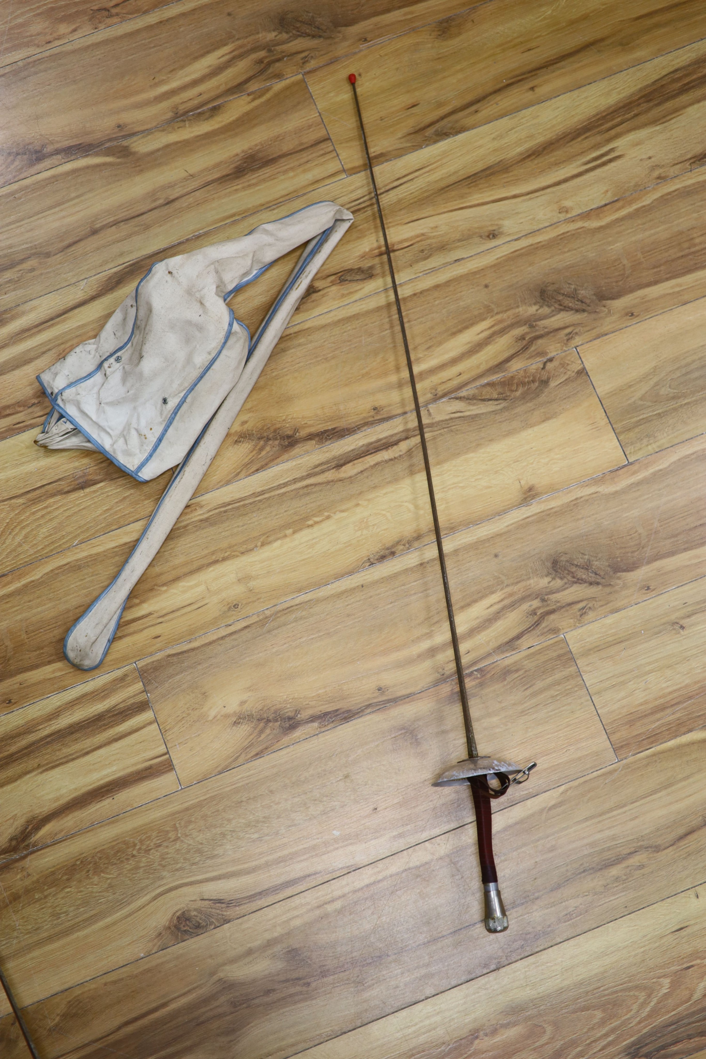 A fencing foil and accessories